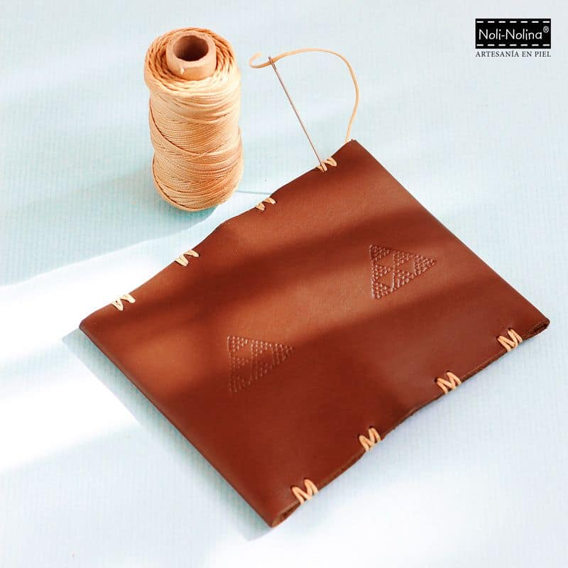 Cartera minimalista de cuero en color chocolate para hombre, con grabado de diferentes pintaderas